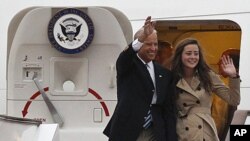 U.S. Vice President Joseph Biden and his daughter Ashley Biden wave after arriving at the Capital International Airport in Beijing, China, Wednesday, Aug. 17, 2011