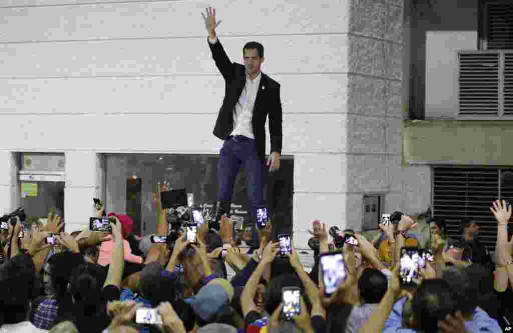 Opposition leader Juan Guaido waves to supporters during a rally at Bolivar Plaza in Chacao, Venezuela, Feb. 11, 2020. Guaido returned home from a tour of nations that back his effort to oust socialist leader Nicolas Maduro.