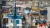 FILE - Fishing boats are moored adjacent to the South Pier of Bridlington Harbour fishing port in Bridlington, north east England, Dec. 11, 2020. 