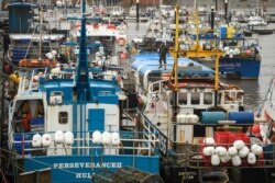 FILE - Fishing boats are moored adjacent to the South Pier of Bridlington Harbour fishing port in Bridlington, north east England, Dec. 11, 2020.