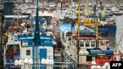FILE - Fishing boats are moored adjacent to the South Pier of Bridlington Harbour fishing port in Bridlington, north east England, Dec. 11, 2020. 