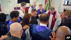 At the Bolling Air Force Base chapel, Katharine Jefferts Schori blesses a young airman before he leaves for a tour in the Middle East.