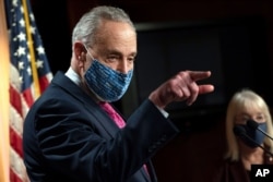 FILE - Senate Majority Leader Chuck Schumer of N.Y. speaks during a news conference on Capitol Hill, Jan. 26, 2021.