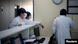 Para perawat berbincang di sebuah klinik di Shanghai di tengah merebaknya wabak virus korona, Shanghai, China, 17 Februari 2020. (Foto: Noel Celis via Reuters)