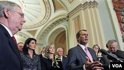 Ketua DPR baru AS, John Boehner berbicara kepada media di Capitol Hill, sementara pemimpin Senat partai Republik Mitch McConnell (kiri) mendengarkan.