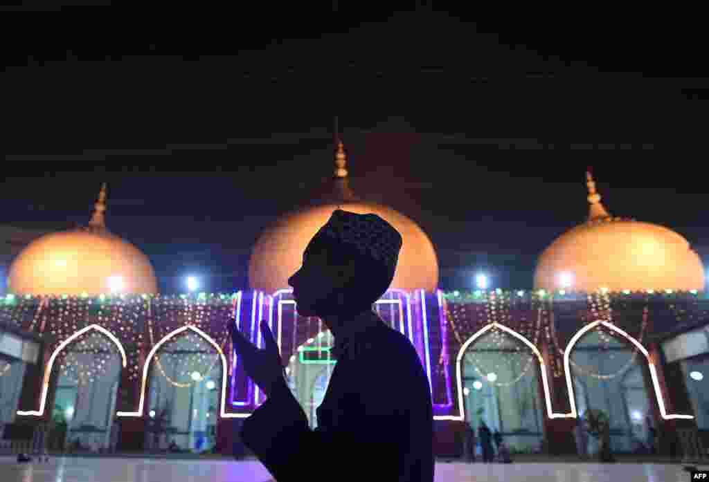 A Muslim prays at an illuminated mosque to mark the Eid-e-Milad-un-Nabi, the birthday of Prophet Mohammad, in Karachi, Pakistan.