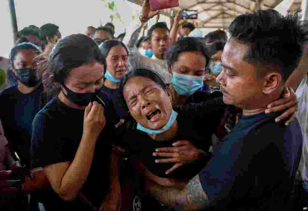 Thida Hnin cries during the funeral of her husband, Thet Naing Win, at the Kyarnikan cemetery in Mandalay, Myanmar. He was shot and killed by security forces during an anti-coup protest on Feb. 20.