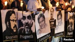 Media members from Sri Lanka hold signs of reporters at the &quot;Black January&quot; vigil to remember what organizers said are the killings and abductions of journalists who have disappeared during the month of January in past years, in Colombo.