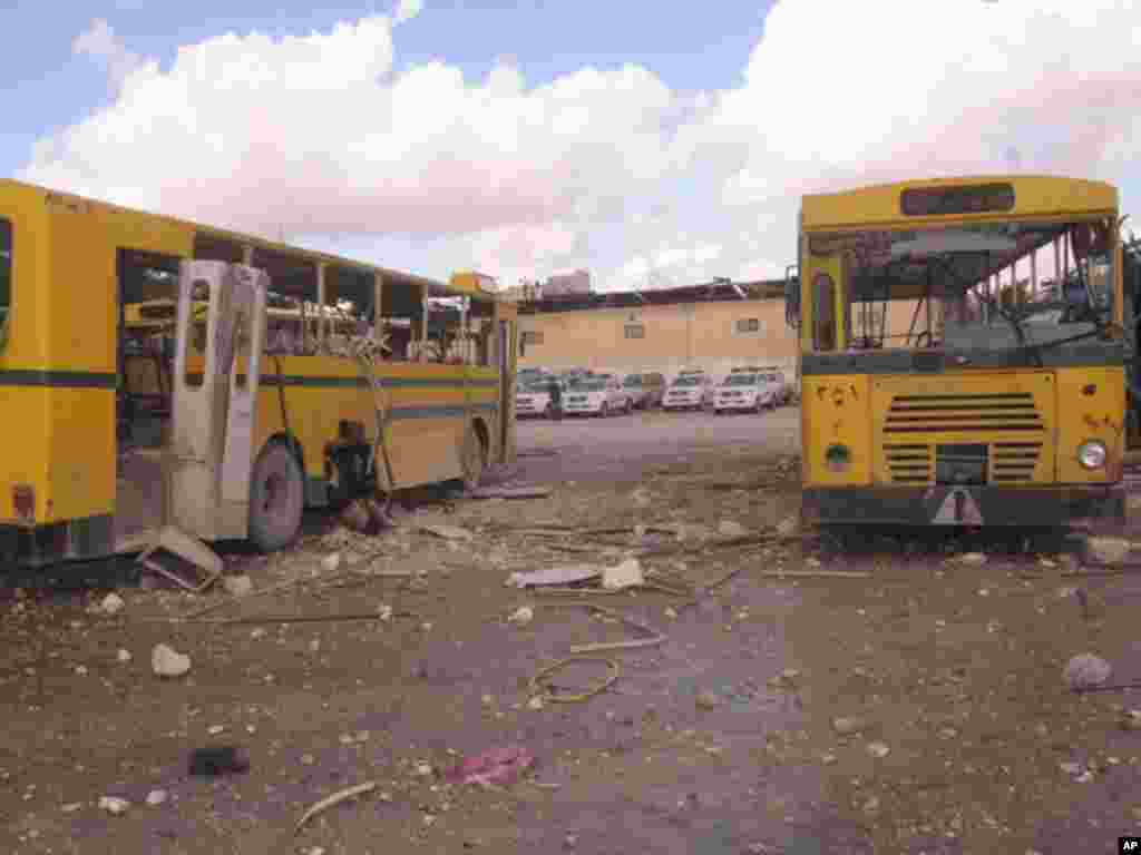 Damaged buses are seen outside the police headquarters building in Aleppo, February 10, 2012. (Reuters)