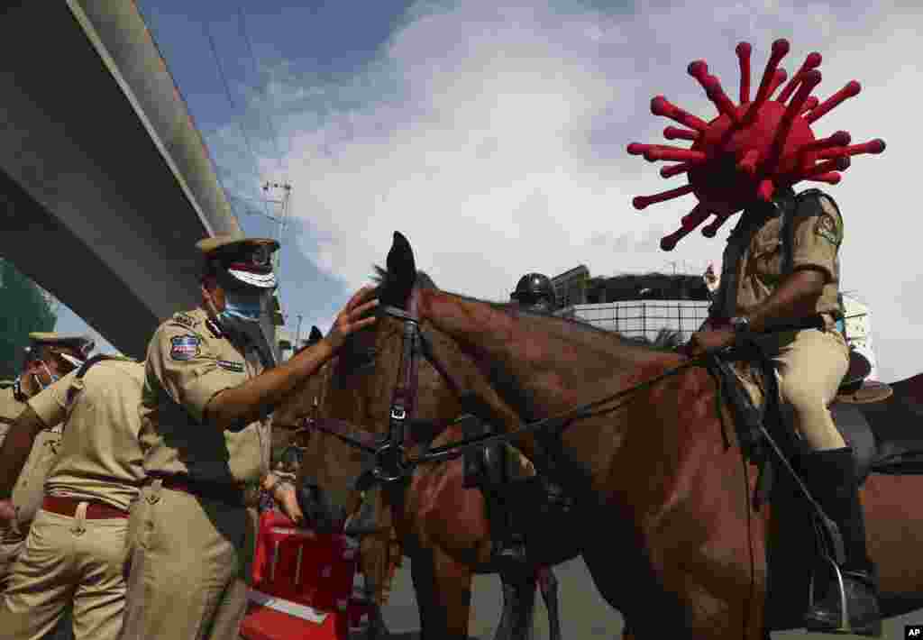 A policeman rides a horse wearing a virus-themed helmet during a COVID-19 awareness drive in Hyderabad, India.