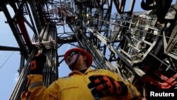 FILE - An employee works at the Centenario deep-water oil platform in the Gulf of Mexico off the coast of Veracruz, Mexico.