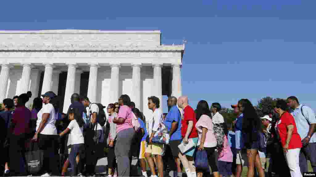 A marcher holds a sign as she attends the 50th anniversary of the 1963 March on Washington for Jobs and Freedom at the Lincoln Memorial in Washington, Aug. 24, 2013. 