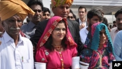 Krishna Kumari, center, newly elected Senator of the Pakistani Hindu Community, arrives at the Parliament with her family members in Islamabad, March 12, 2018. 