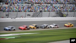 Drivers pass the front stretch during a practice session for the NASCAR Daytona 500 auto race at Daytona International Speedway, Feb. 15, 2020, in Daytona Beach, Fla. 