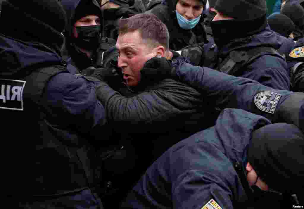 Law enforcement officers restrain a demonstrator during a rally of entrepreneurs and representatives of small businesses amid the COVID-19 outbreak in Kyiv, Ukraine.