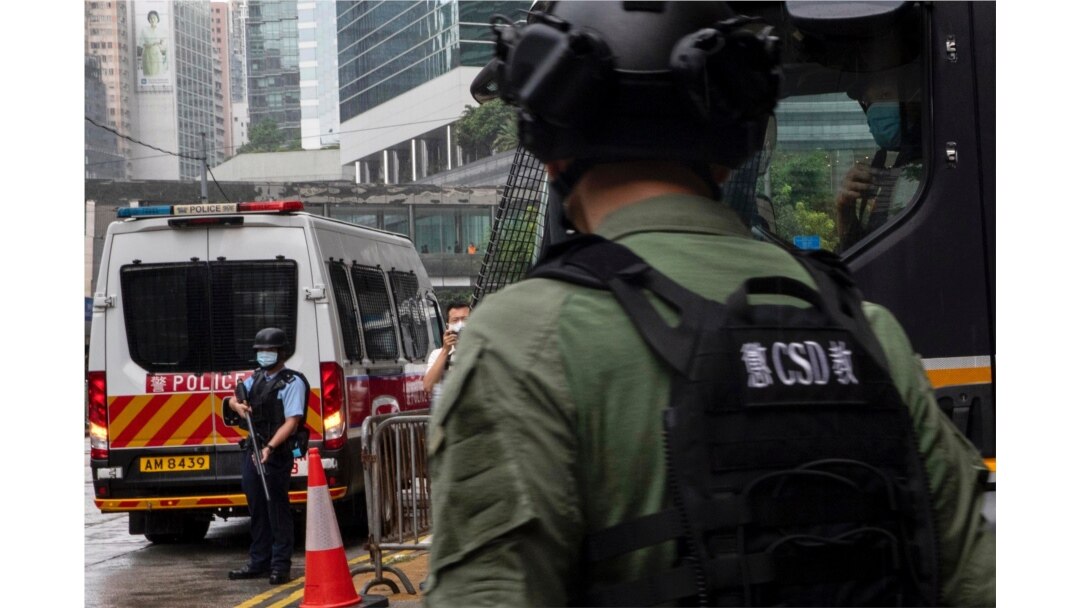Police officers stand outside a court in Hong Kong Aug. 19, 2021. Two Hong Kongers on Thursday pleaded guilty to conspiring to collude with foreign forces as well as Next Digital founder Jimmy Lai to endanger national security according to reports.