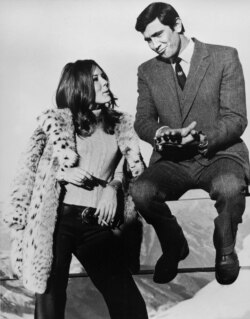 FILE - Actor George Lazenby, the new James Bond, and British actress Diana Rigg share a moment during takes of "On Her Majesty's Secret Service," at Schilthorn near Muerren, Switzerland, Jan. 10, 1969.