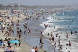 Visitors crowd the beach July 12, 2020, in Santa Monica, Calif., amid the coronavirus pandemic.