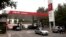 FILE - Motorists pump fuel at a Sinopec gas station in Beijing, China, Aug. 29, 2011. 