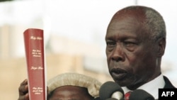 Président Daniel arap Moi azali kolapa ndayi na Biblia na maboko na Nairobi, Kenya, 5 janvier 1998.