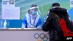 A man asks for transportation information at the MPC media centre help desk,