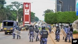 FILE - Security forces block the street leading to the Electoral Commission during a visit by Ugandan opposition presidential candidate Bobi Wine in Kampala, Uganda, Dec. 2, 2020. 