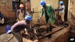 Residents excavate at the site of a recently-discovered mass grave in Gasabo district, near the capital Kigali, in Rwanda, April 26, 2018