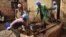 Residents excavate at the site of a recently-discovered mass grave in Gasabo district, near the capital Kigali, in Rwanda, April 26, 2018