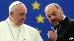 Pope Francis, left, listens to E.U. Parliament President Martin Schulz at the European Parliament in Strasbourg, in eastern France, Nov. 25, 2014.