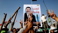 Supporters of Egypt's Islamist President Mohammed Morsi flash victory signs during a rally, Nasser City, Cairo, July 3, 2013.