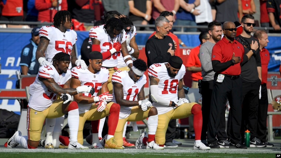 FILE - Members of the San Francisco 49ers kneel during the national anthem before an NFL football game against the Los Angeles Rams, Dec. 31, 2017, in Los Angeles. 