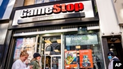 FILE - Pedestrians pass a GameStop store on 14th Street at Union Square, Jan. 28, 2021, in the Manhattan borough of New York. 