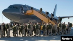 Canadian Armed Forces members from 4 Wing Cold Lake, Alberta, depart for their deployment, Oct. 22, 2014.