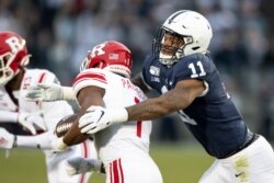FILE - Penn State linebacker Micah Parsons (11) tackles Rutgers tight end Johnathan Lewis (11) in the first quarter of an NCAA college football game, in State College, Pennsylvania, Nov. 30, 2019.