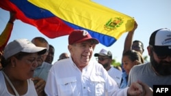 FILE - Venezuelan opposition presidential candidate Edmundo Gonzalez Urrutia greets supporters upon his arrival at the campaign act in Barlovento Town in Miranda State, Venezuela, on June 26, 2024.