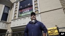 FILE - In this June 14, 2020, file photo, James Juanillo poses outside of his home in San Francisco. (AP Photo/Jeff Chiu, File)