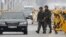 South Korean soldiers patrol as vehicles returning from North Korea's inter-Korean Kaesong Industrial Complex back to South Korea arrive at a checkpoint on the Grand Unification Bridge, which leads to the demilitarized zone separating North Korea from Sou