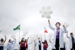 Nurses hold balloons during a protest asking for COVID-19 vaccines, in Brasilia, Brazil, April 7, 2021.