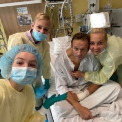 FILE - This handout picture posted Sept. 15, 2020, on the Instagram account of @navalny shows Russian opposition leader Alexey Navalny with his family at Berlin's Charite hospital.