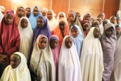 FILE - Released Nigerian girls who had been kidnapped from their school in Dapchi, in the northeastern state of Yobe, wait to meet Nigerian president Mohammadu Buhari at the Presidential Villa, in Abuja, March 23, 2018.