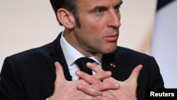 French President Emmanuel Macron gestures as he gives a speech to outline France's revamped strategy for Africa ahead of his visit in Central Africa,Paris, February 27, 2023. 