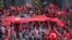 Turkish citizens wave their national flags as they protest against the military coup outside Turkey's parliament near the Turkish military headquarters in Ankara, Turkey, July 16, 2016. 