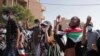 FILE: Sudanese calling for a civilian government march near the presidential palace in Khartoum, Sudan, Tuesday, 11.30.2021. Security forces have fired tear gas at anti-coup protesters in the Sudanese capital, disrupted phone service, and cut access to the Internet.

