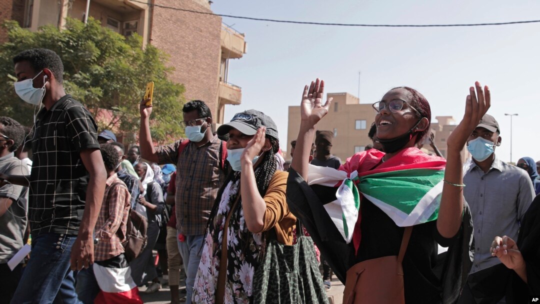 FILE: Sudanese calling for a civilian government march near the presidential palace in Khartoum, Sudan, Tuesday, 11.30.2021. Security forces have fired tear gas at anti-coup protesters in the Sudanese capital, disrupted phone service, and cut access to the Internet.
