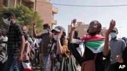 FILE: Sudanese calling for a civilian government march near the presidential palace in Khartoum, Sudan, Tuesday, 11.30.2021. Security forces have fired tear gas at anti-coup protesters in the Sudanese capital, disrupted phone service, and cut access to the Internet.
