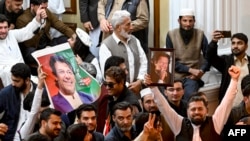Supporters of jailed former prime minister Imran Khan's Pakistan Tehreek-e-Insaf party show portraits of Khan during an oath-taking ceremony of newly elected members at the provincial legislature of Pakistan's Khyber Pakhtunkhwa Assembly in Peshawar on Feb. 28, 2024. 