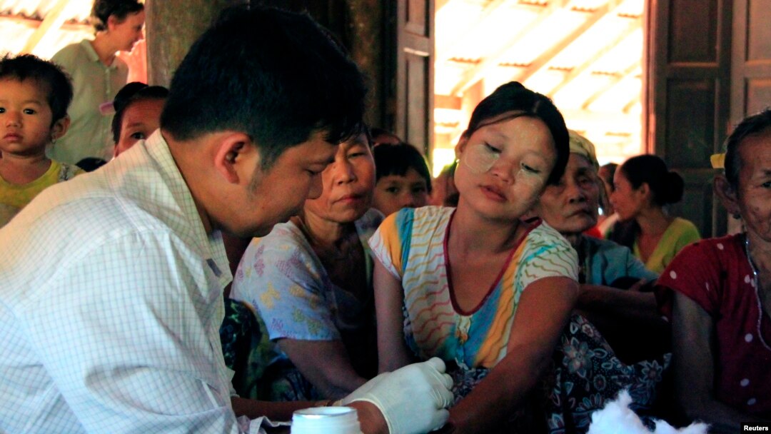 A government health worker takes a blood sample from a woman to be tested for malaria in Ta Gay Laung village hall in Hpa-An district in Kayin state, southeastern Myanmar, Nov. 28, 2014.
