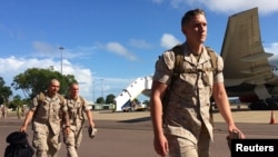 U.S. Marines walk after disembarking a plane after they arrived for the annual Marines' deployment at Darwin in northern Australia, April 18, 2017. 