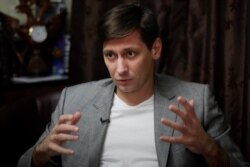 FILE - Russian opposition candidate Dmitry Gudkov gestures during his interview with the Associated Press in Moscow, March 11, 2020.