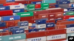 FILE - Containers sit stacked at Port 2000 terminal in Le Havre harbor, eastern France, Sept. 6, 2018.